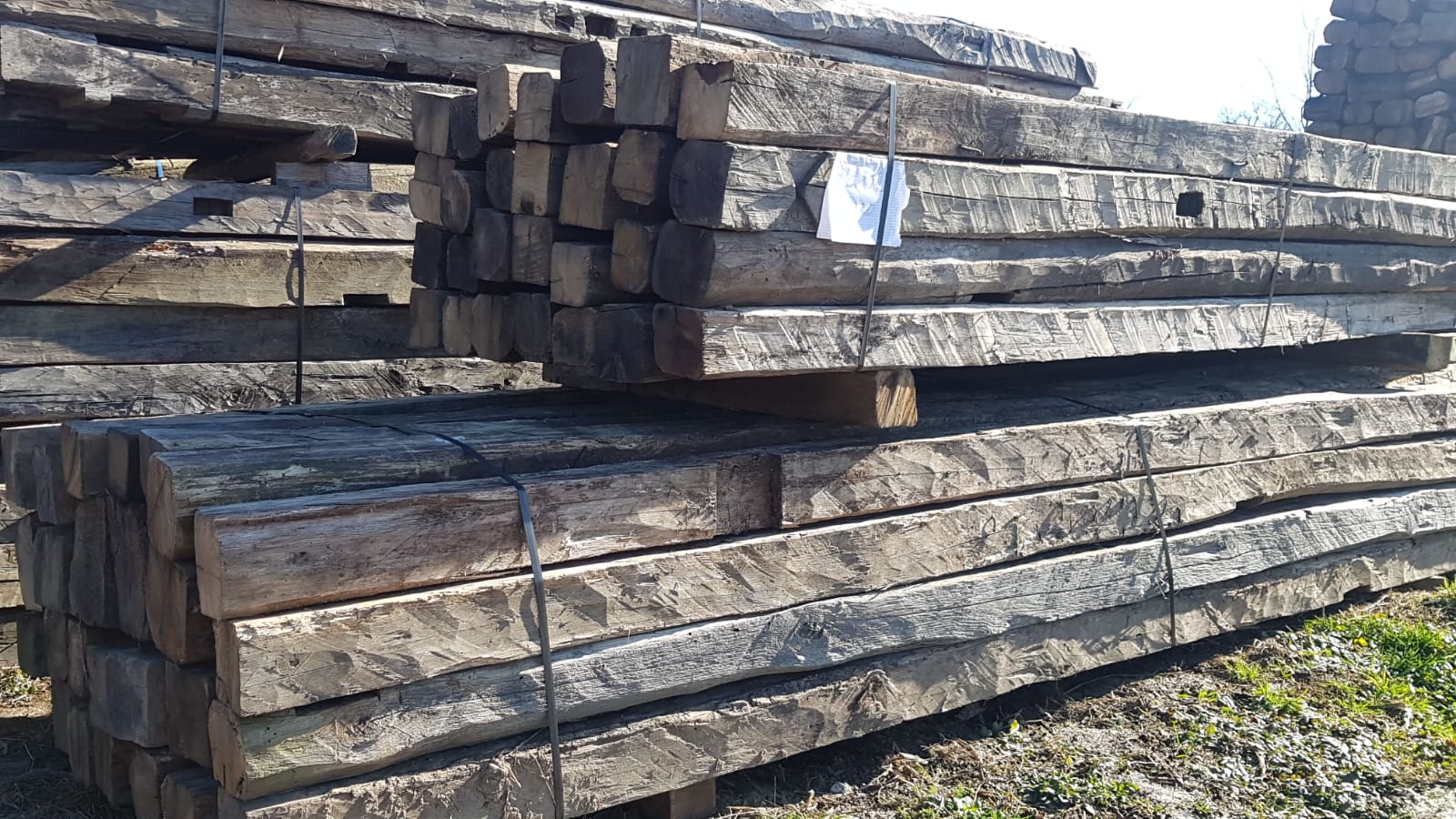 Close-up of hand-hewn antique oak beams showing axe marks and original surface texture