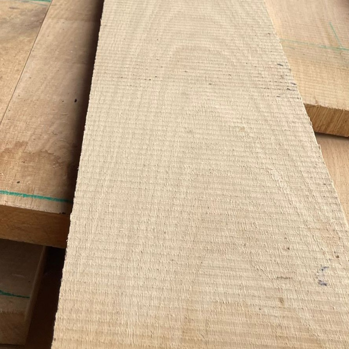Square-format close-up of rough sawn European white oak board surface