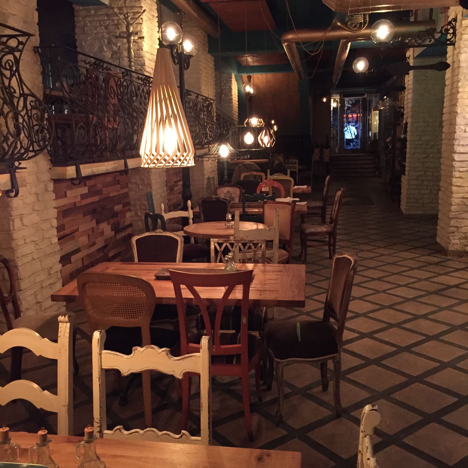 Restaurant hall with reclaimed oak tables and eclectic seating