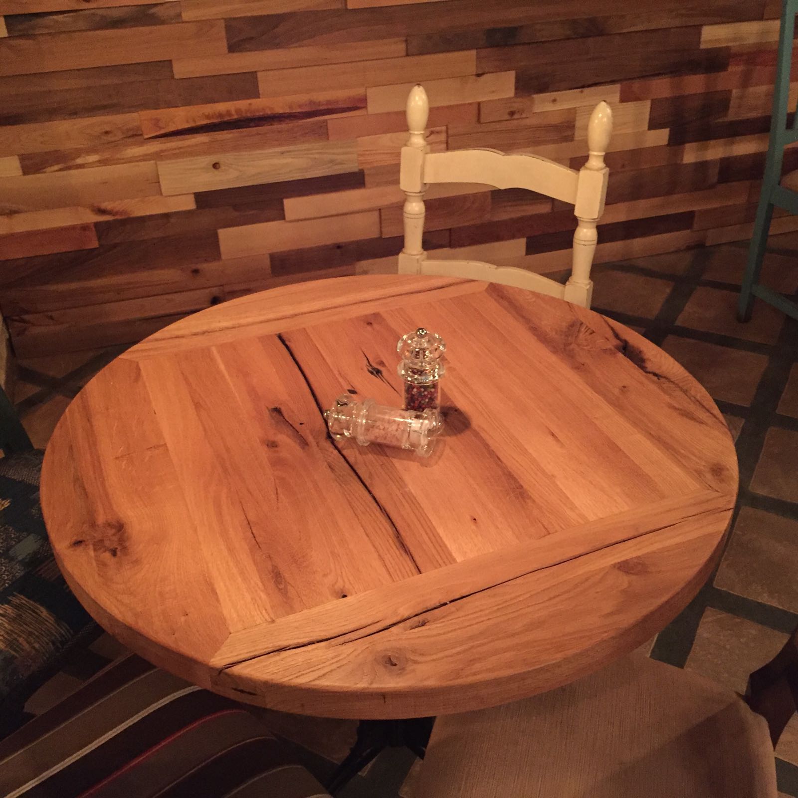 Round reclaimed oak restaurant table, natural finish