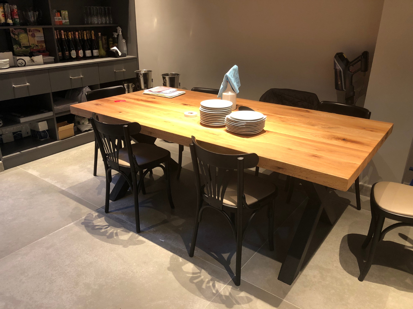 Solid wood restaurant dining table with bistro chairs, close-up detail
