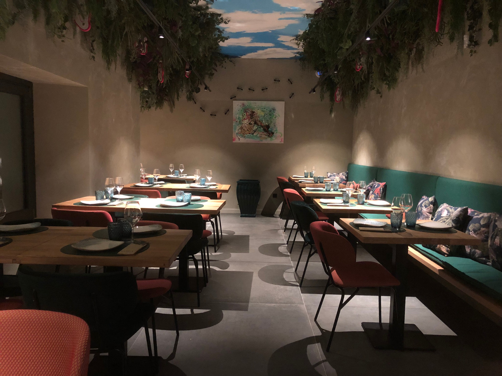 Restaurant interior with upholstered seating, banquette and solid wood tables