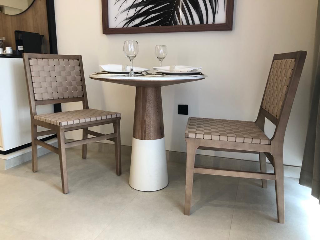 Finished solid wood dining table with woven chairs, custom European furniture